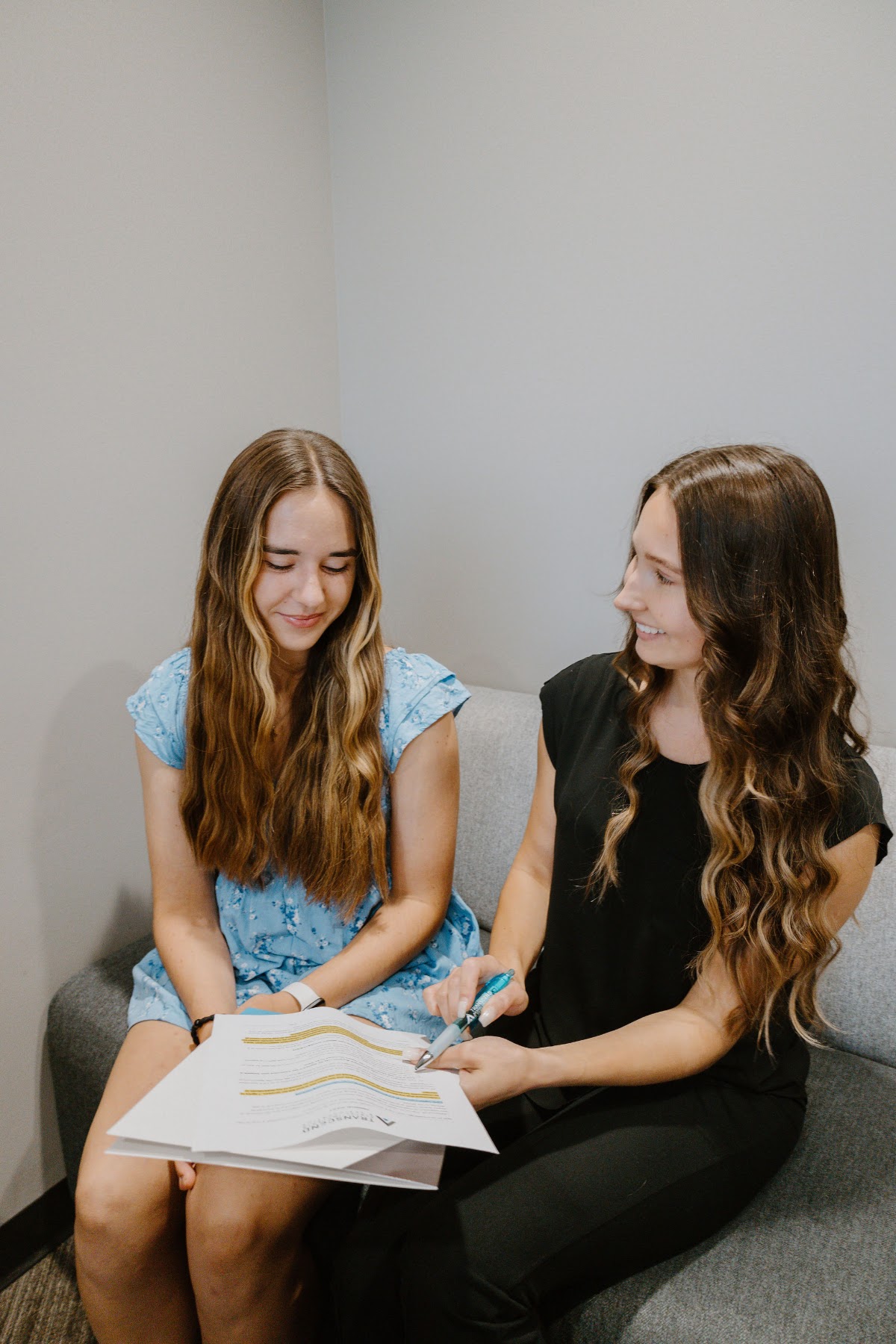 Transcend team member reviewing a treatment plan with a patient in the consultation lounge