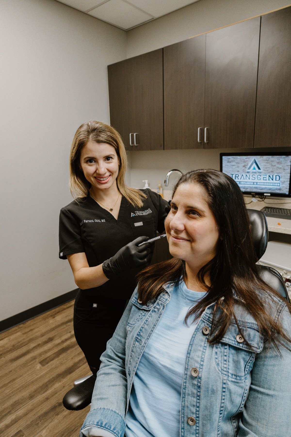 Transcend team member and patient smiling together after treatment