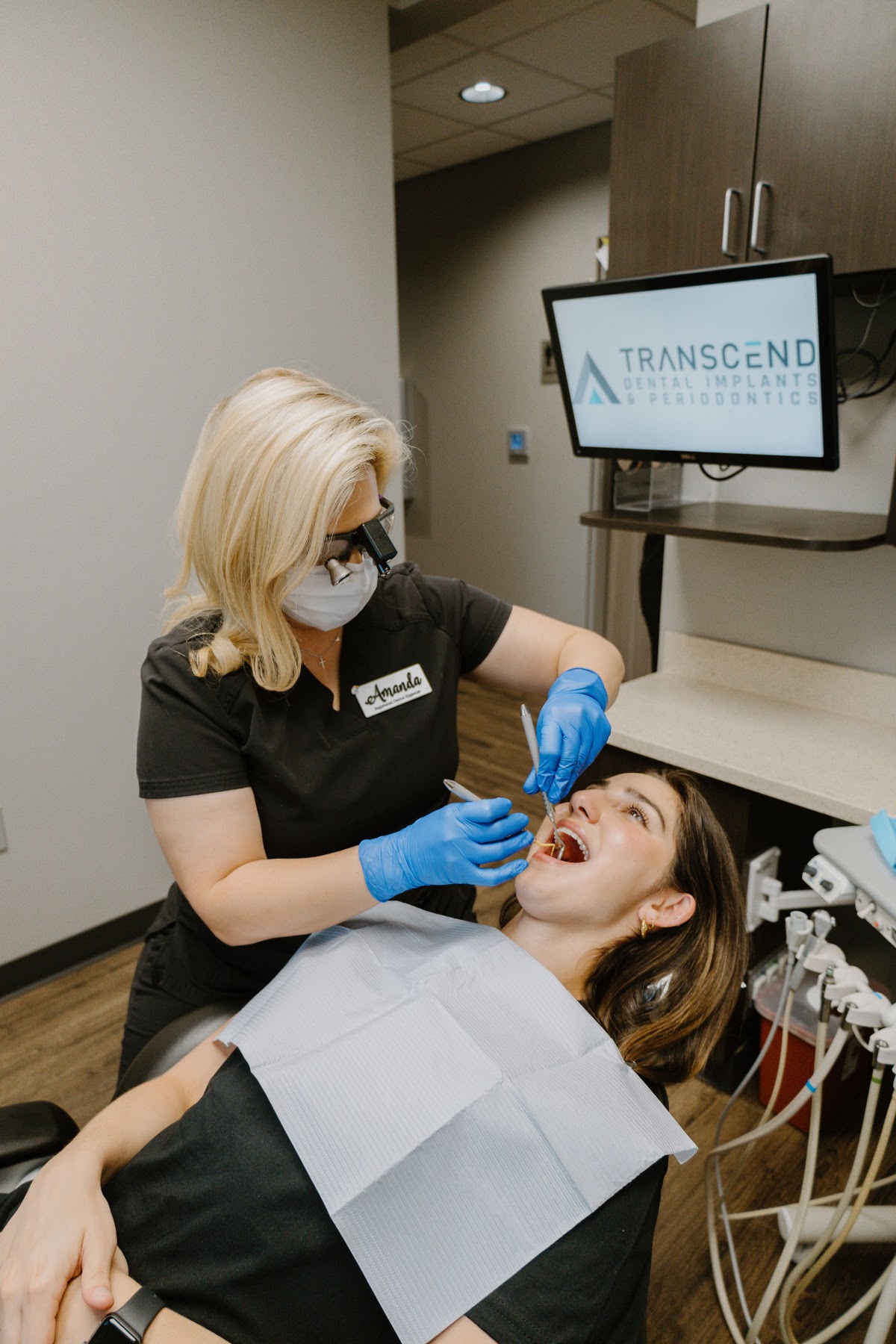 Transcend hygienist treating a patient in the operatory